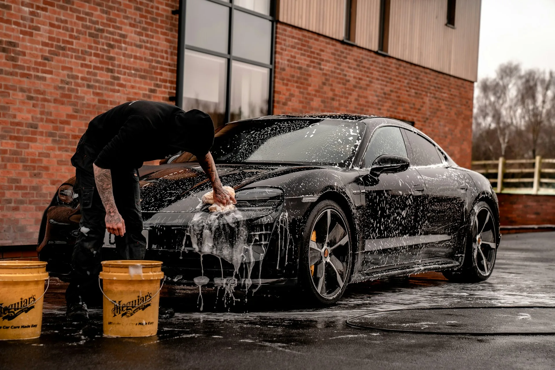 Guy washing Porsche Taycan - Car Detailing